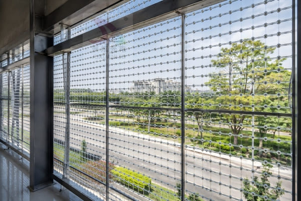View from inside a building looking out through a transparent LED mesh screen during the day